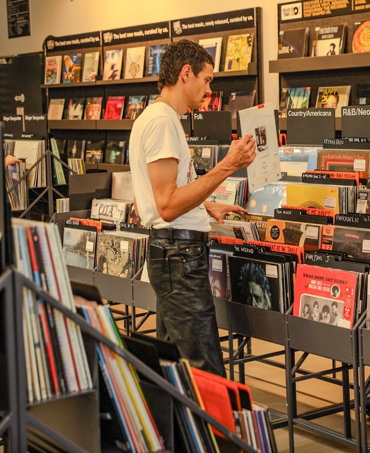Record shopper digging for records at Rough Trade Berlin