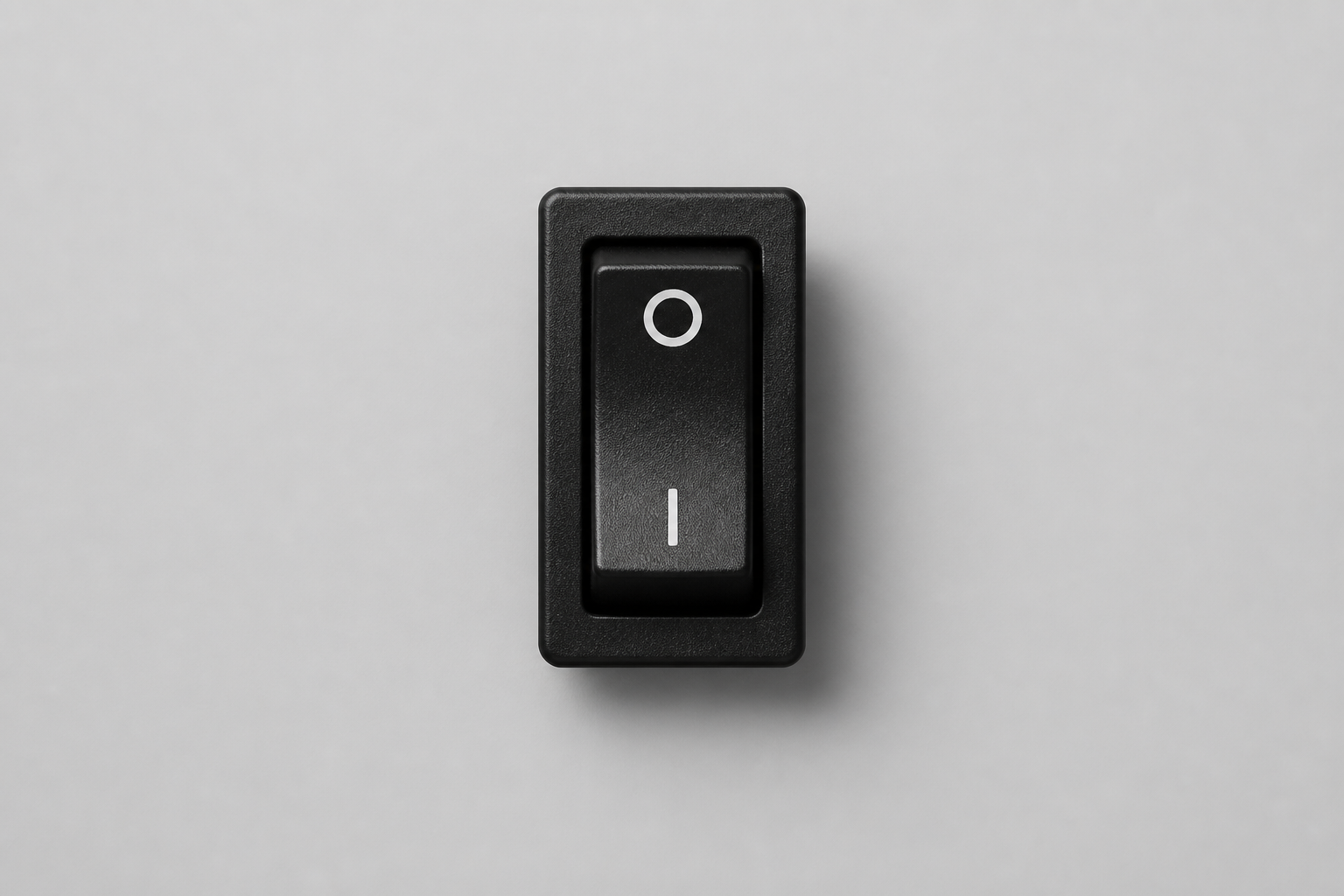 A centered physical power switch in the off position on a solid background