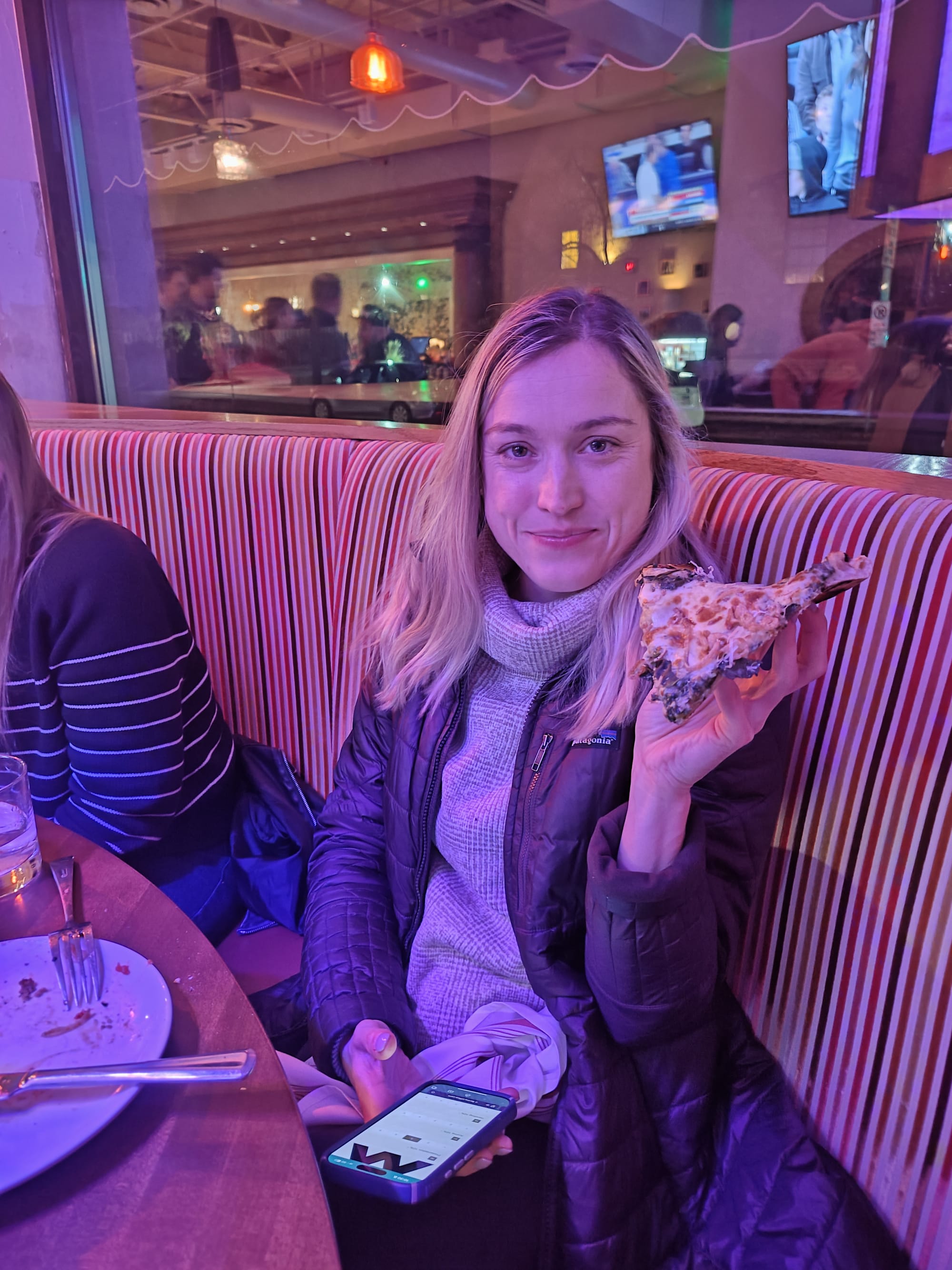 woman holding pizza