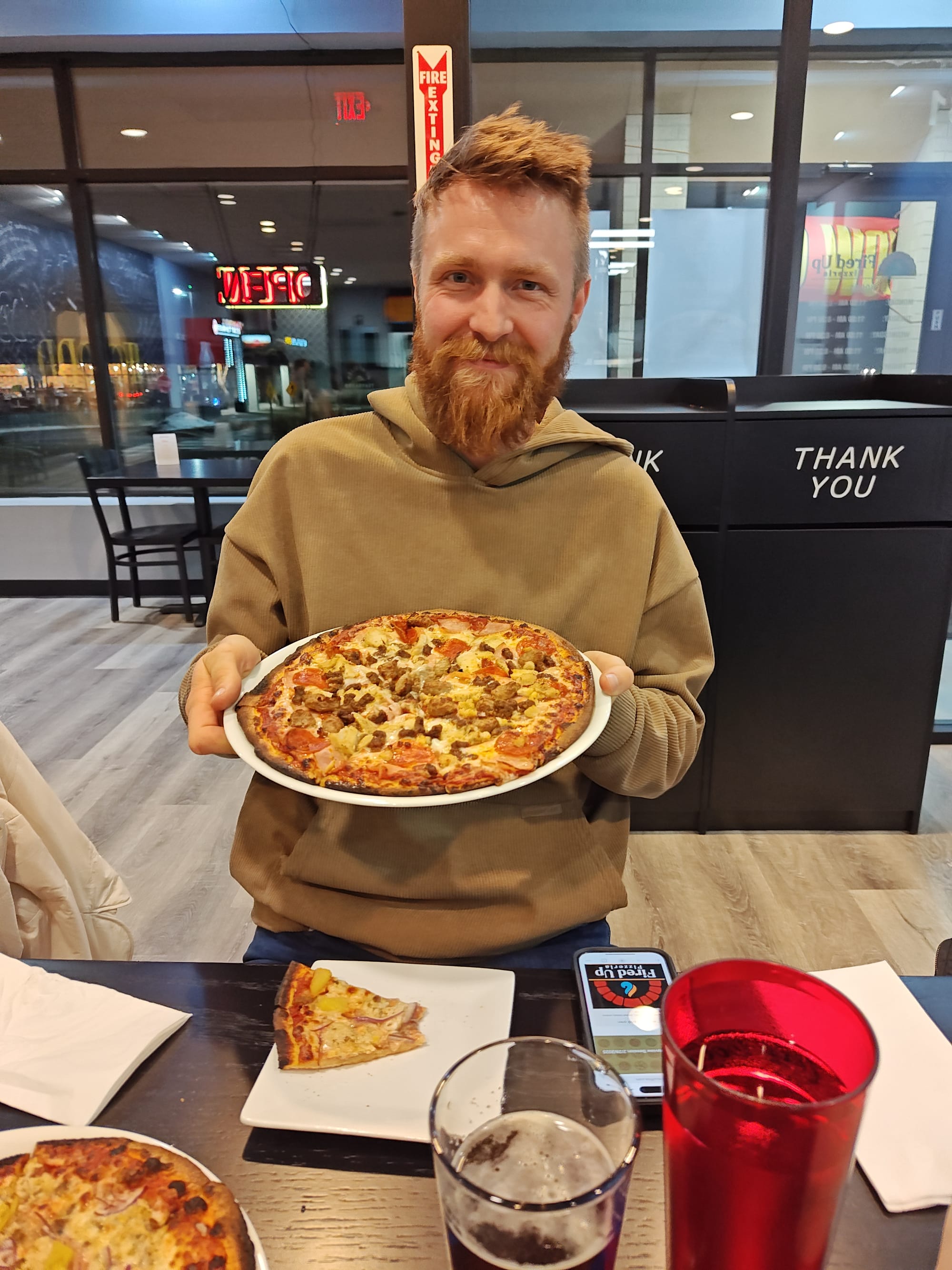 man holding a meat pizza