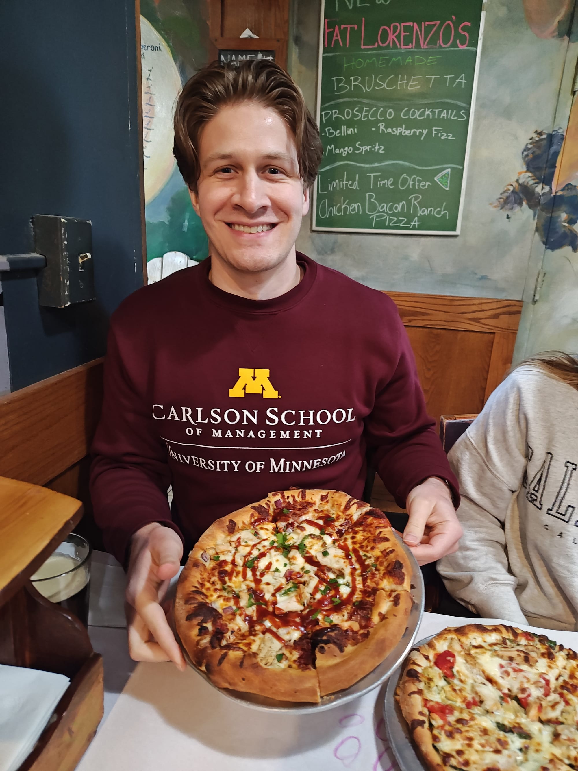 man holding a bbq pizza
