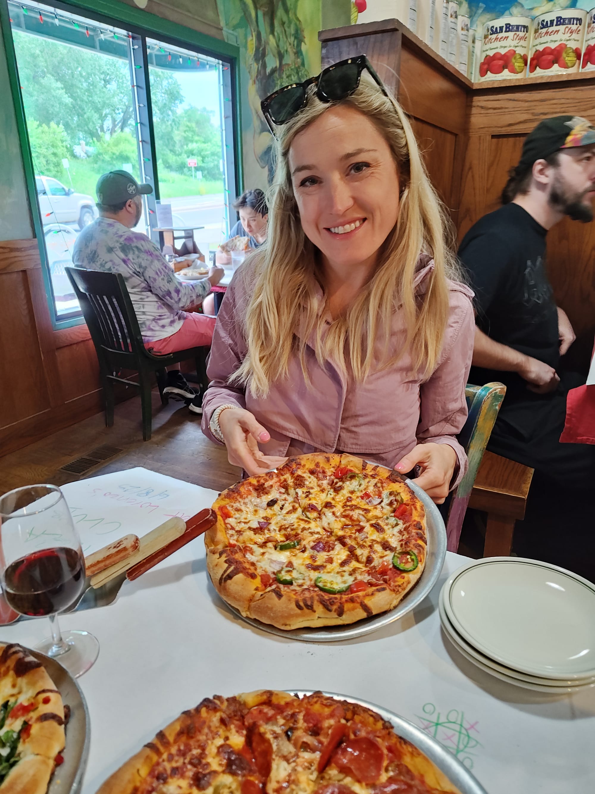 woman holding a chorizo pizza