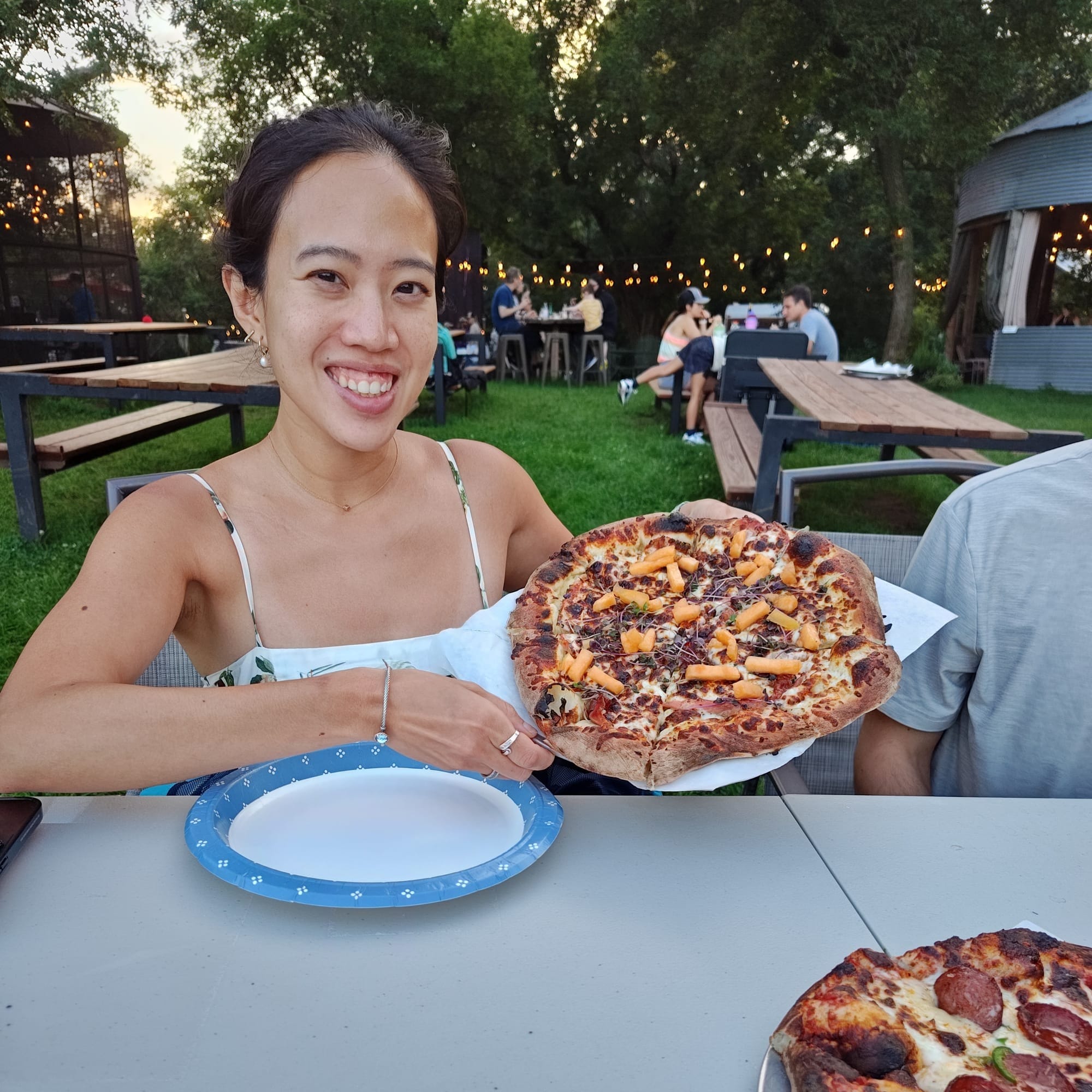 woman holding a cantaloupe pizza