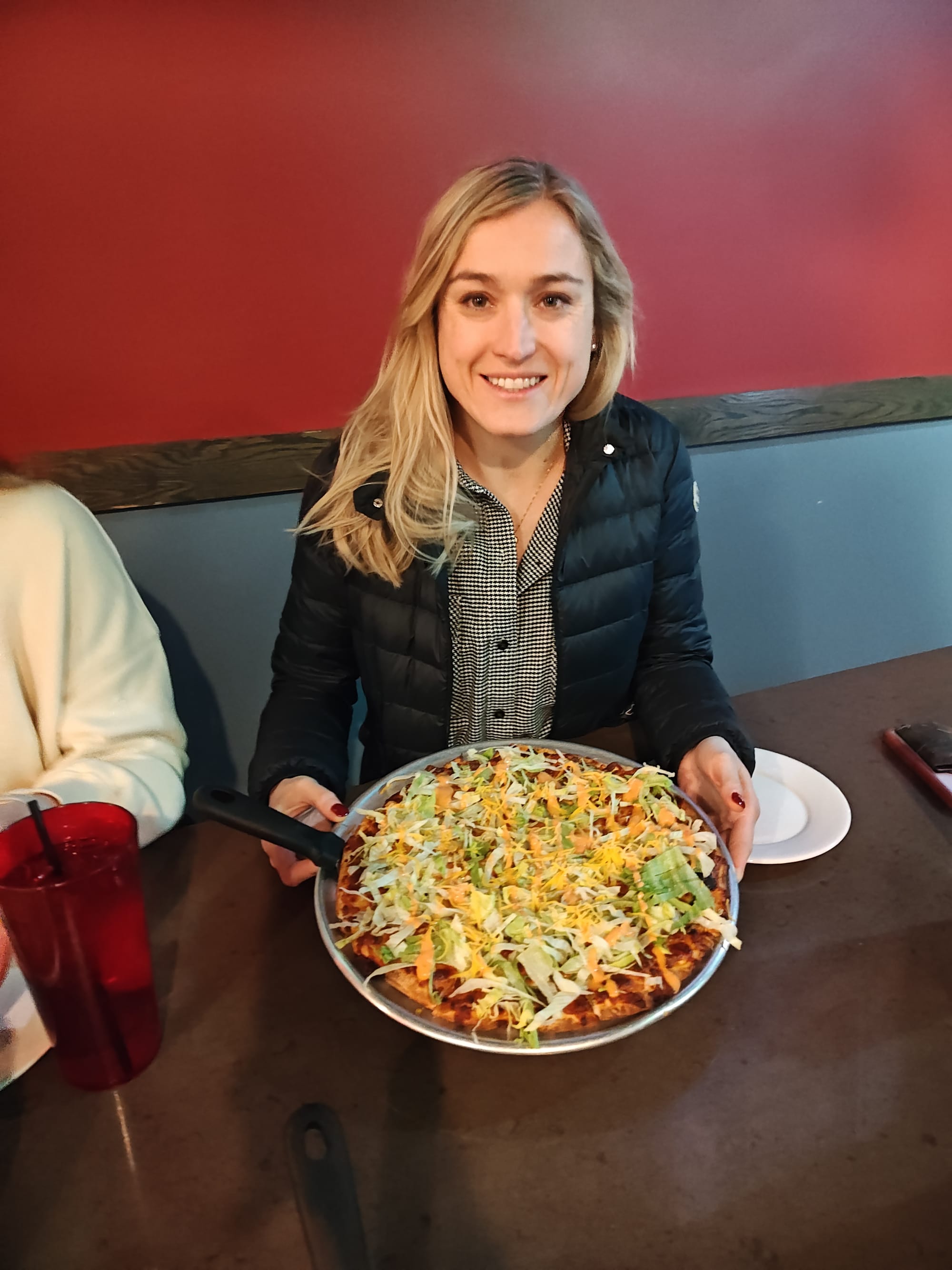 woman holding a McDonald's Big Mac flavored pizza
