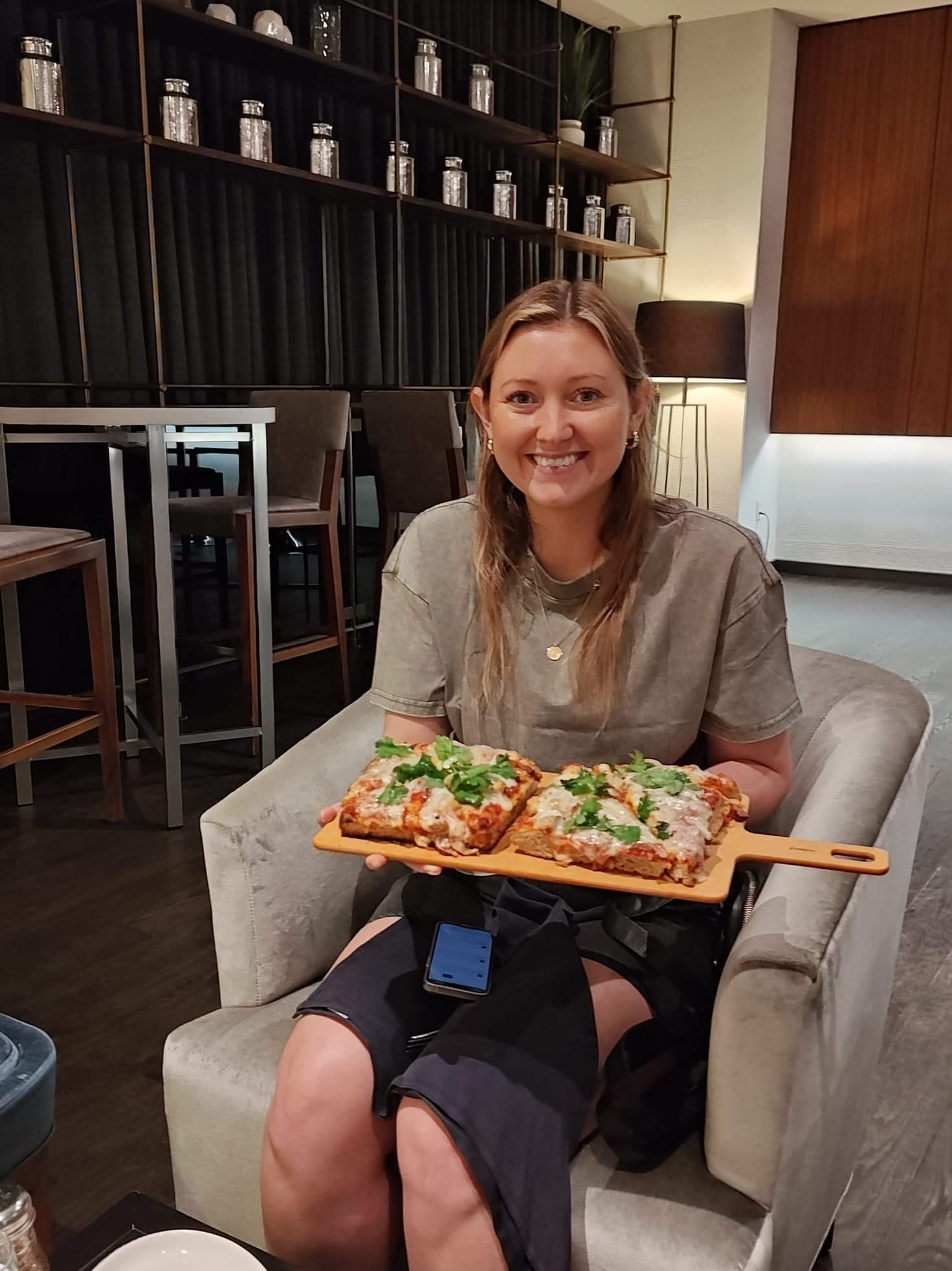 woman holding a spicy pork pizza