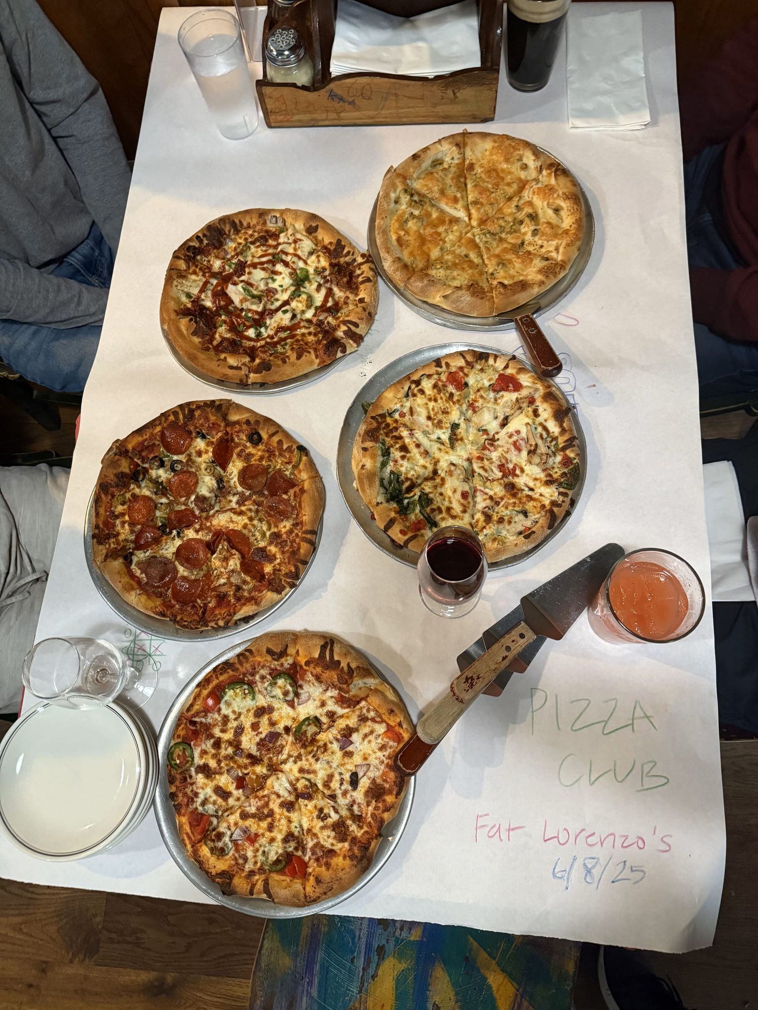 overhead picture of five, different, circular, italian, pizzas on a table
