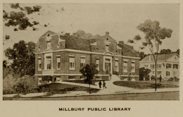 The Millbury Public Library, circa 1915. The building is brick, two people walk in front of it. The Torrey Mansion can be seen in the back.