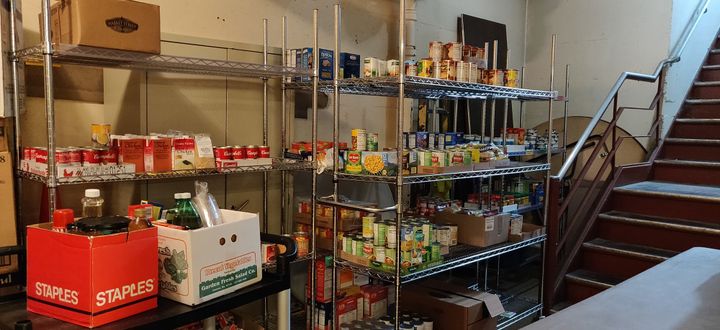 Food on rolling racks in a hallway.