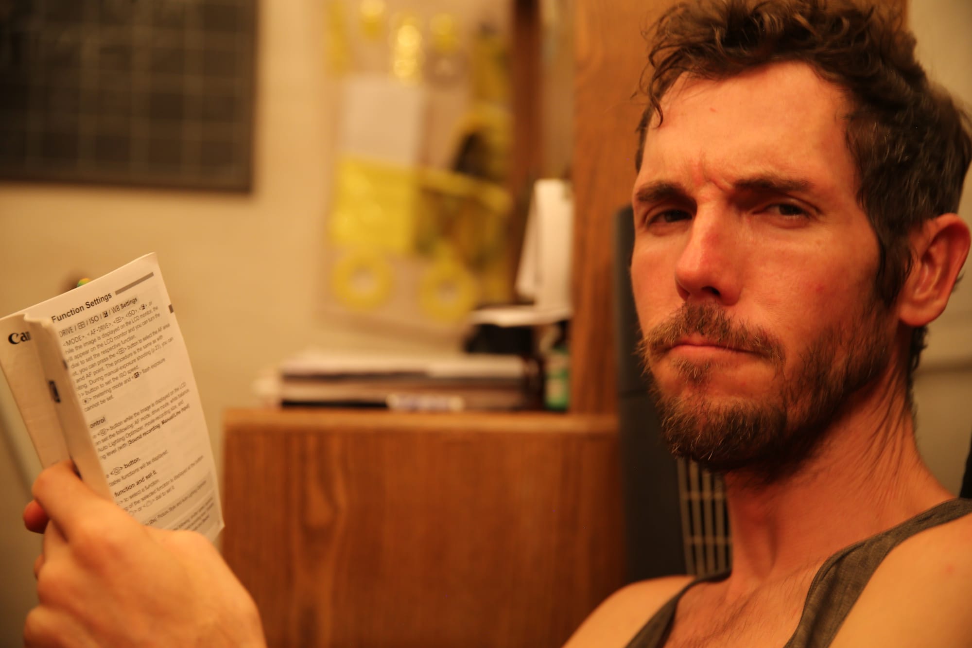 Professor Gray Balls holding a instruction manual making a suspicious facial expression.