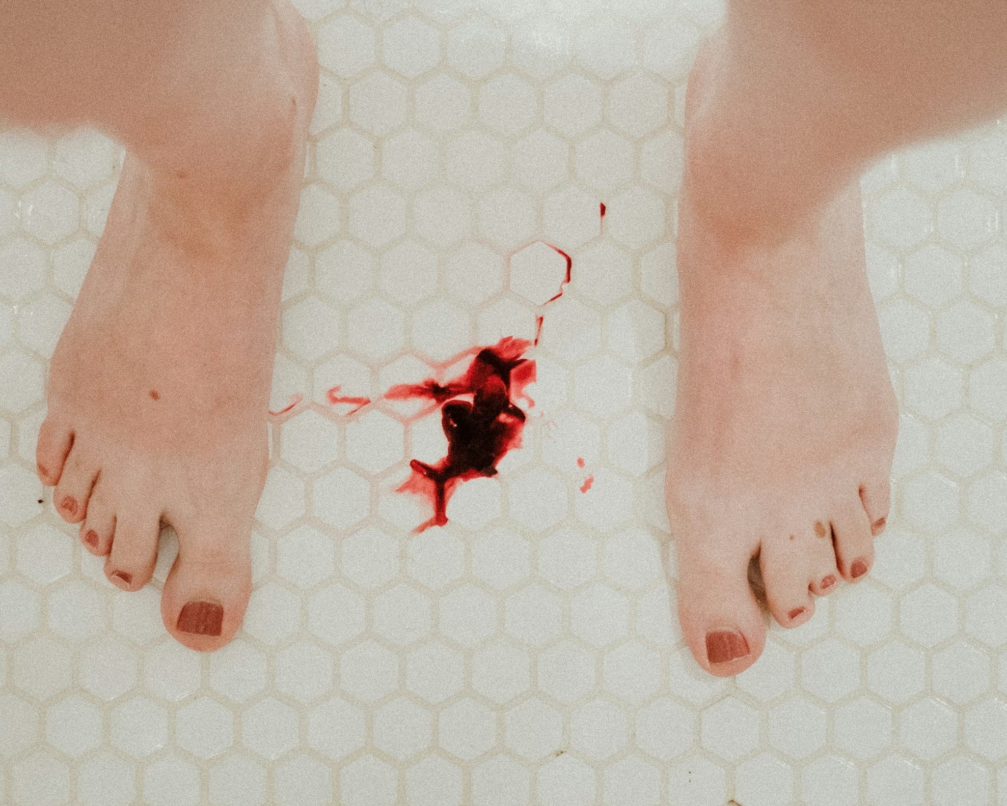 person standing on white ceramic floor tiles