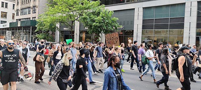 Protestors demonstrating against the killing of Jordan Neely walk down NYC's Madison Avenue.