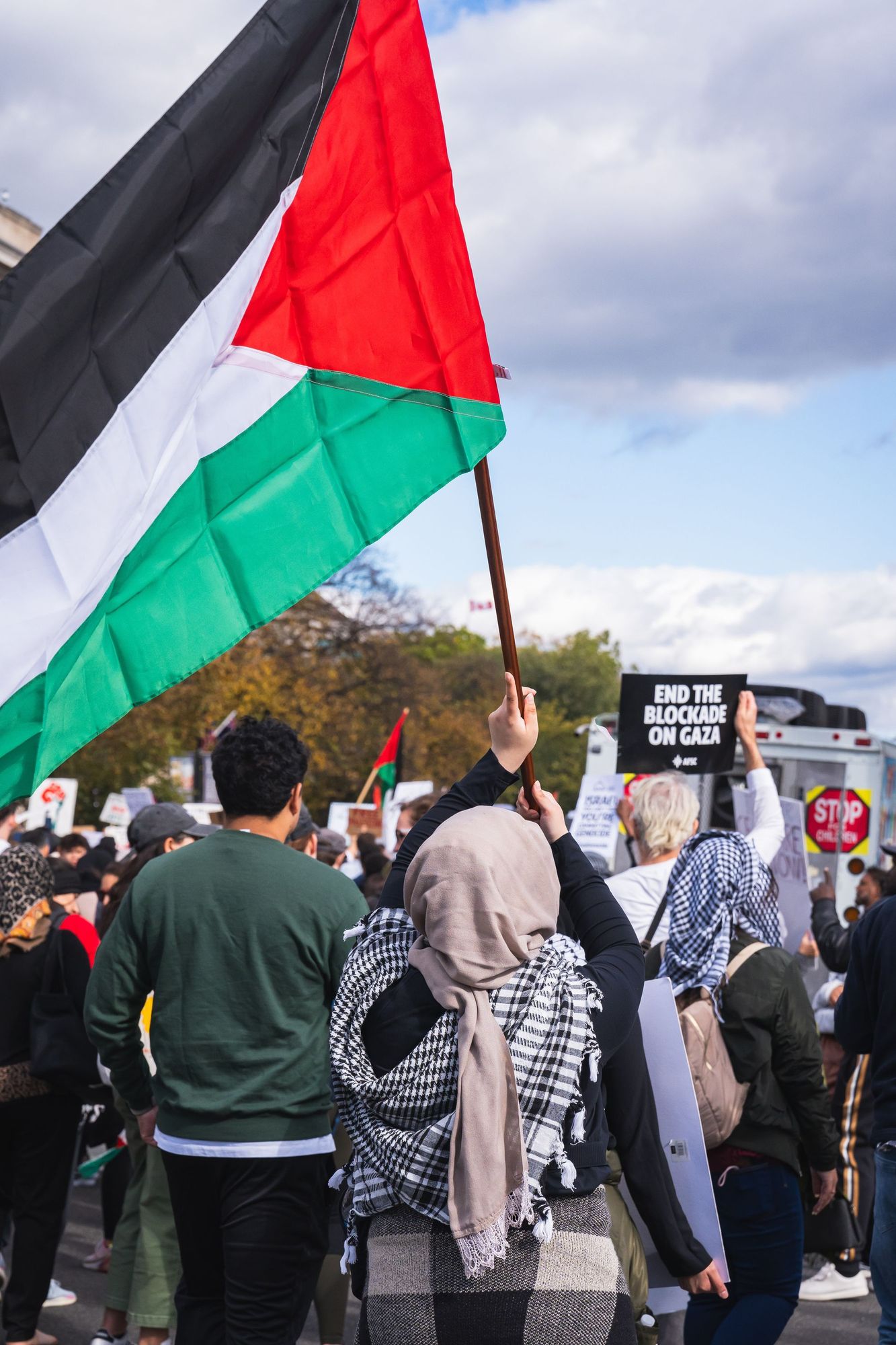 Pro-Palestinian demonstrators marching in Washington DC with a Palestinian flag held aloft. 