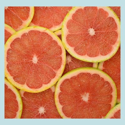 Slices of pink grapefruit arranged edge to edge