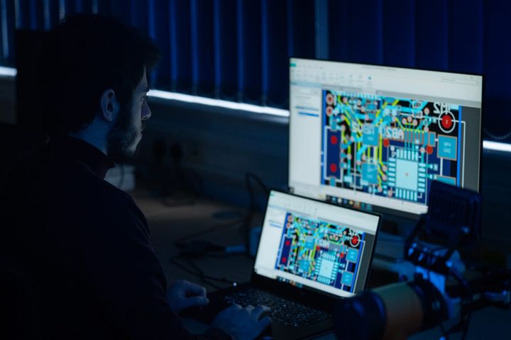 Man looking at a screen focused on technical diagrams 