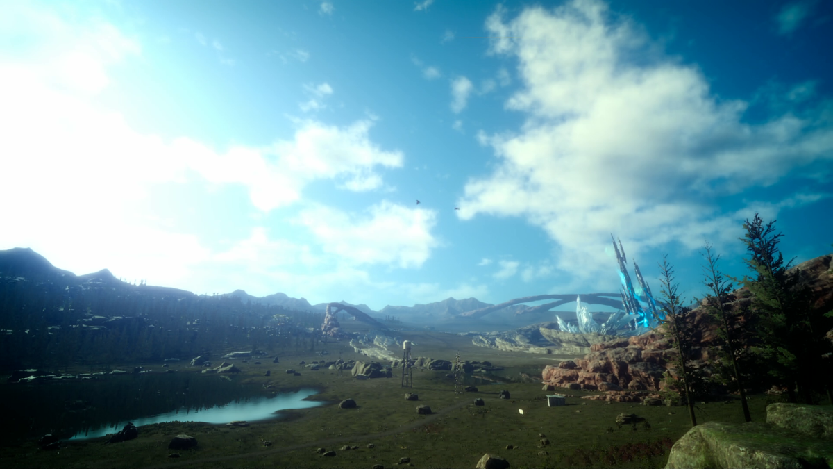 A spectacular view of a grassy plain with a lake.