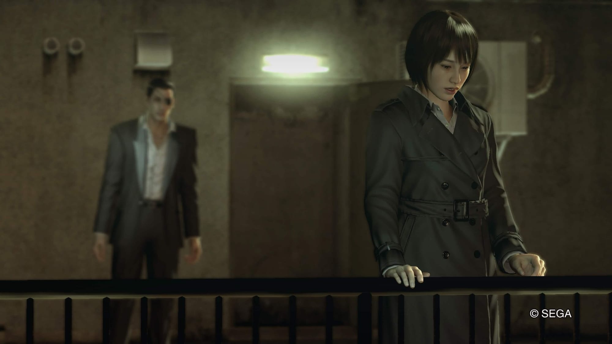 "A Yakuza 0 screenshot of Makoto Makimura looking downwards past a railing with Goro Majima standing off in the background."