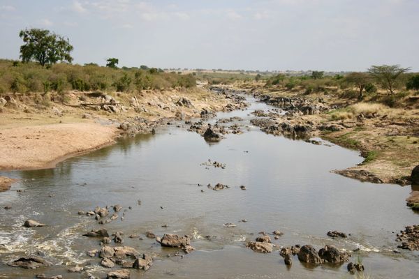 A Rocky river with wide shallow banks perfect for a migratory crossing in Africa.
