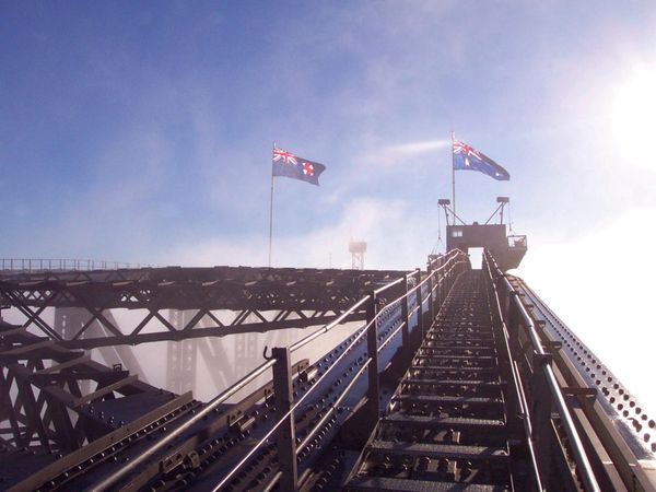 Taken from the ascent up the right hand side of the bridge focusing on the steel path to Australian flags flying at the pinnacle.