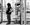Person in a hooded jacket waits at a bus stop