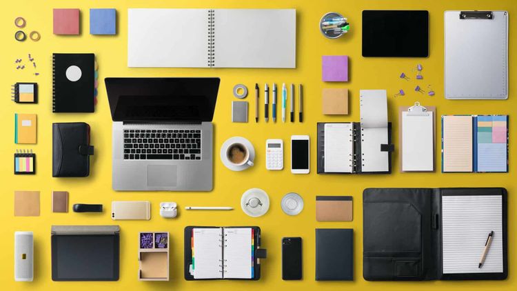 Flat lay top view office desk working space with laptop on yellow background