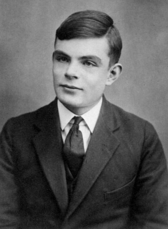 Teenage portrait of Alan Turing in jacket and tie.