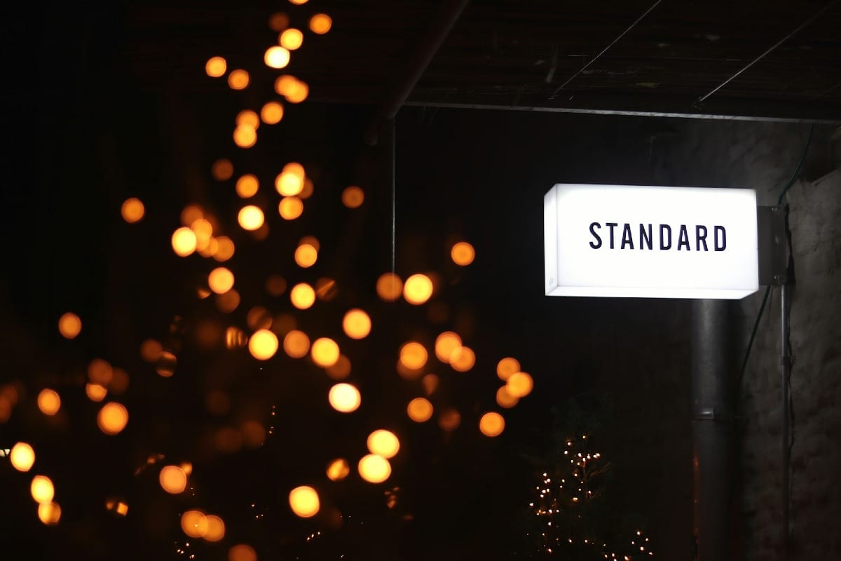 A white LED signage mounted on wall with the word 'Standard' in black text