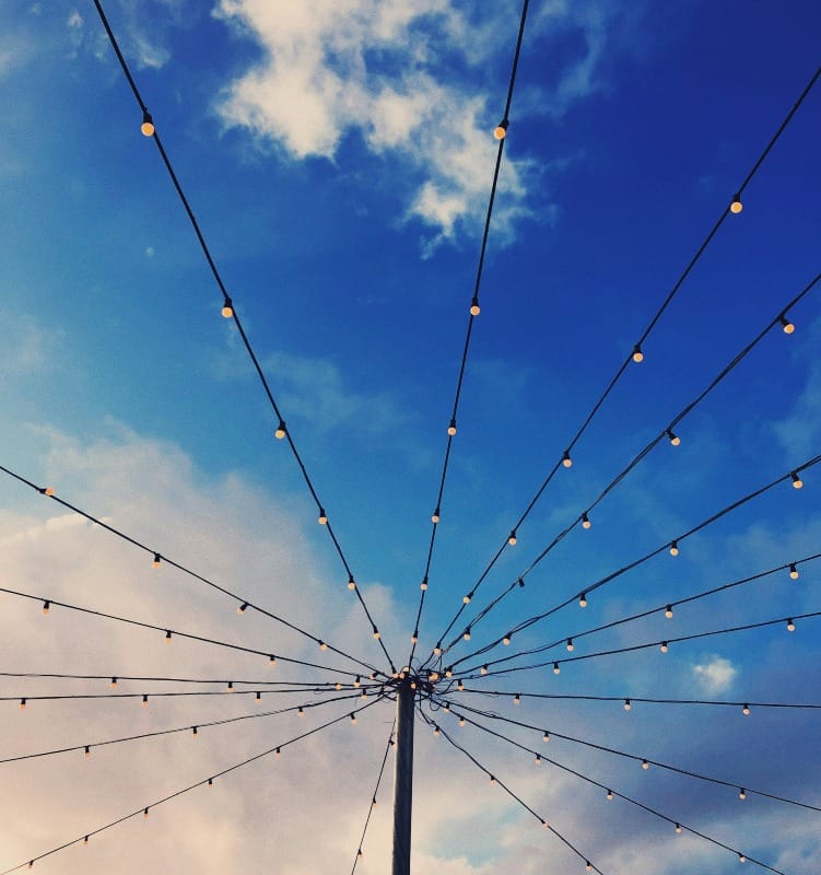 Multiple string lights connected to a pole and straightened outwards