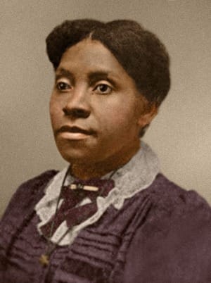 Headshot of a brown skinned Black woman dressed with a white collar and dark top in a colorized photo.
