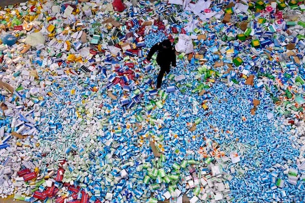 This picture taken on March 14 shows a Chinese policeman walking across a pile of fake medicines seized in Beijing in recent months, which were later destroyed. The rapid growth of Internet commerce has led to an explosion of counterfeit drugs sold around the world, with China the biggest source of fake medicines, pharmaceutical experts said as the illicit trade is now believed to be worth around 75 billion USD globally, with criminal gangs increasingly using the web to move their products across borders. CHINA OUT AFP PHOTOSTR/AFP/Getty Images ORG XMIT: