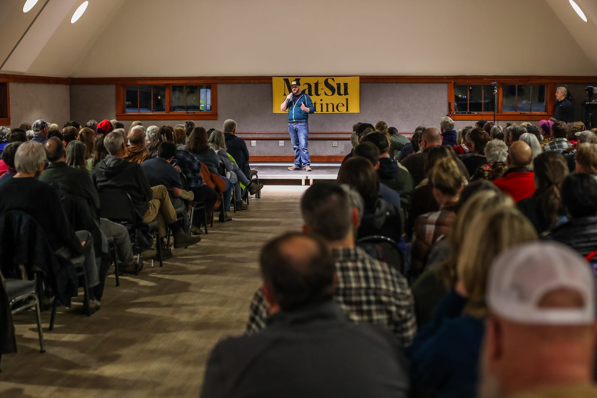 Tim Rockey speaks to a sold-out crowd