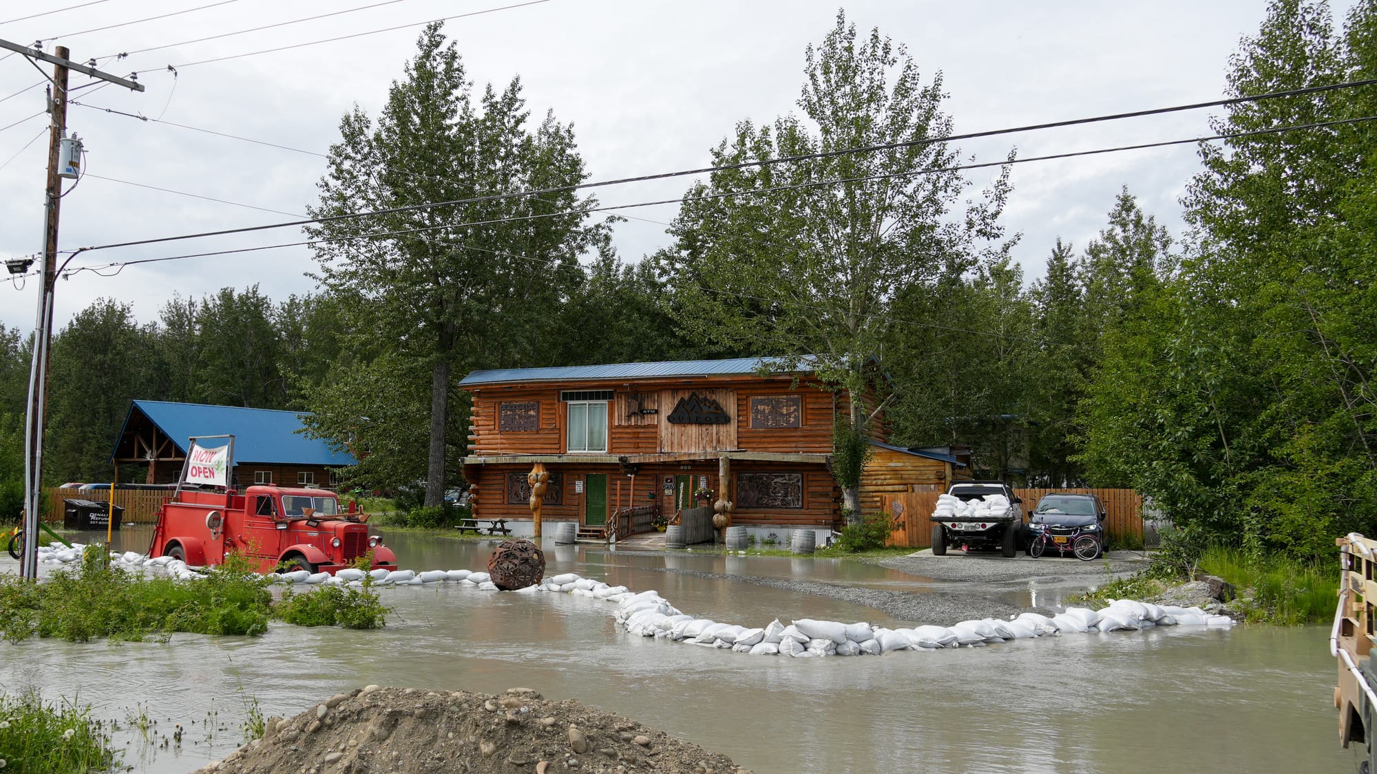 Sand bags divert flooding in front of the OutPost Cannabis Boutique and Store