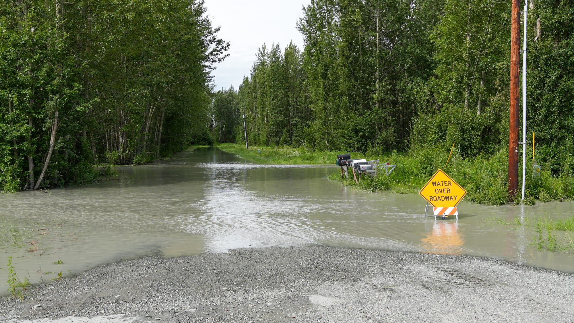 Flooding from the Matanuska River covers the roadway at Ye Old River Road