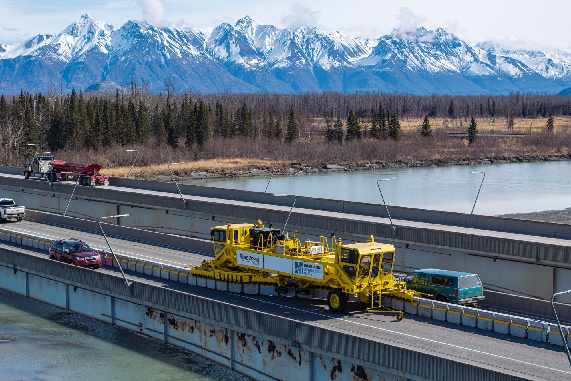 The Road Zipper machine shifts barriers along the southbound span of the Knik River bridge