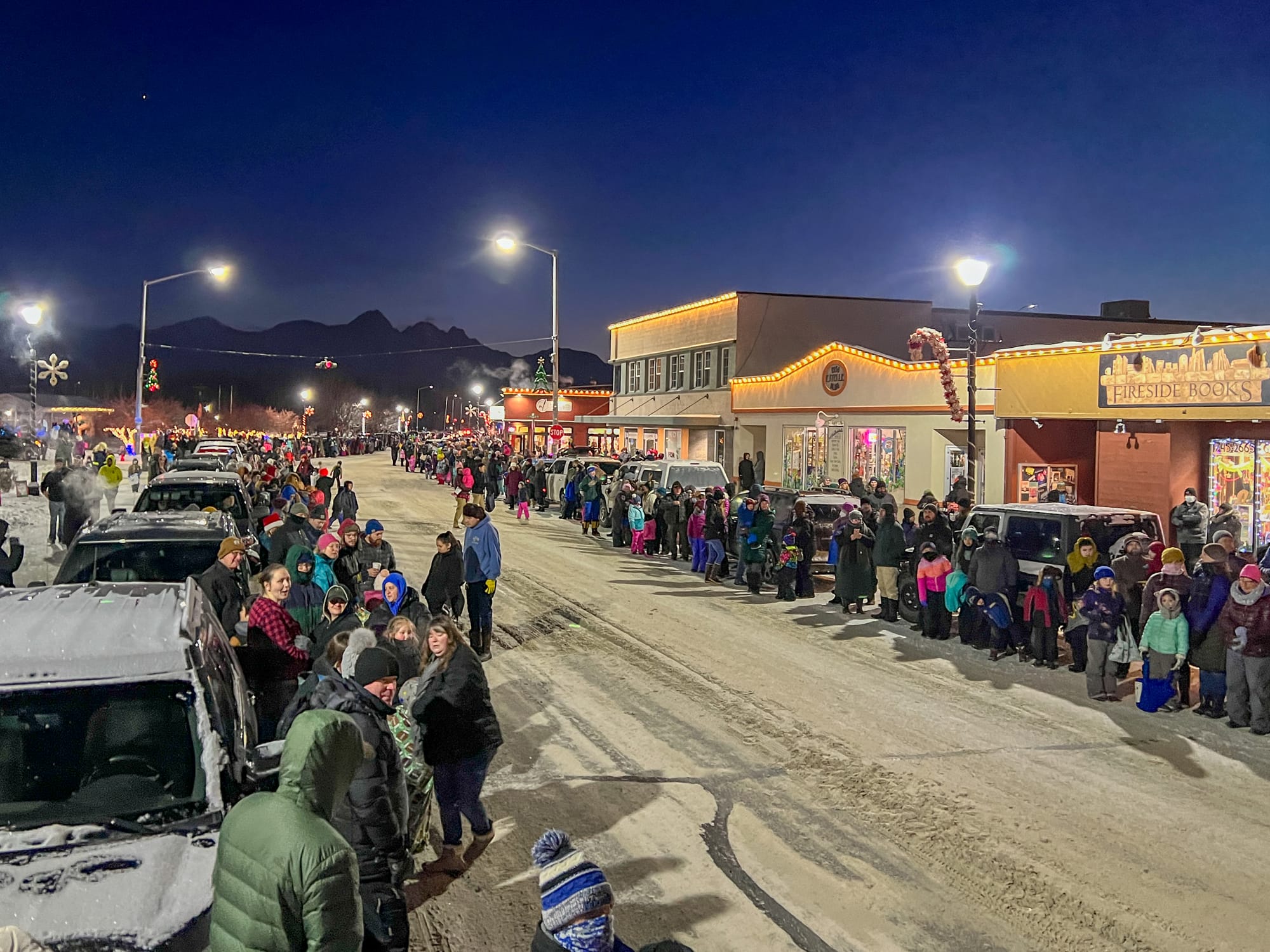 Parade-goers line the street ahead of the annual Colony Christmas parade