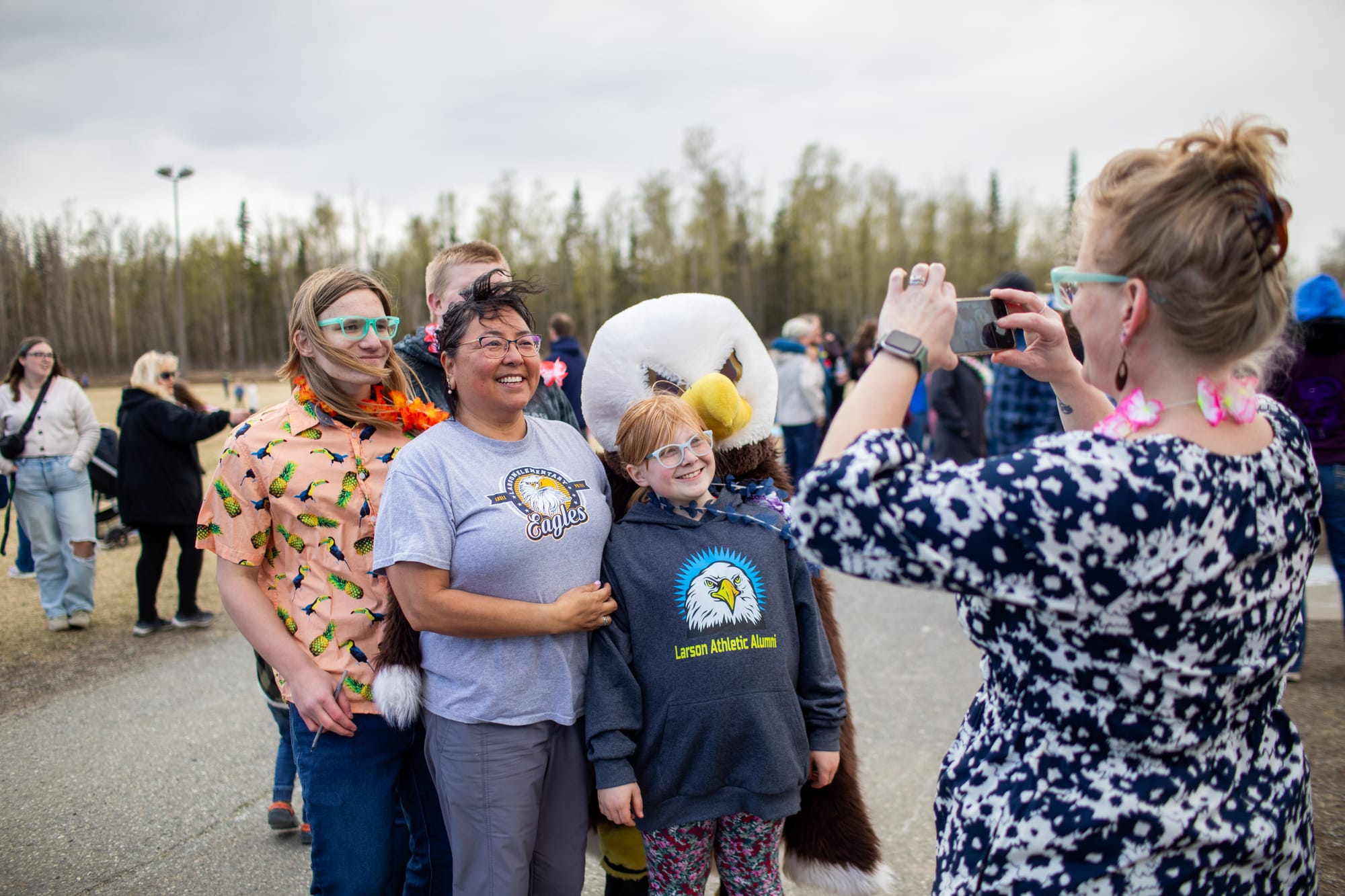 Fifth-grade teacher Roberta LaPalm, center, poses with the school mascot alongside students