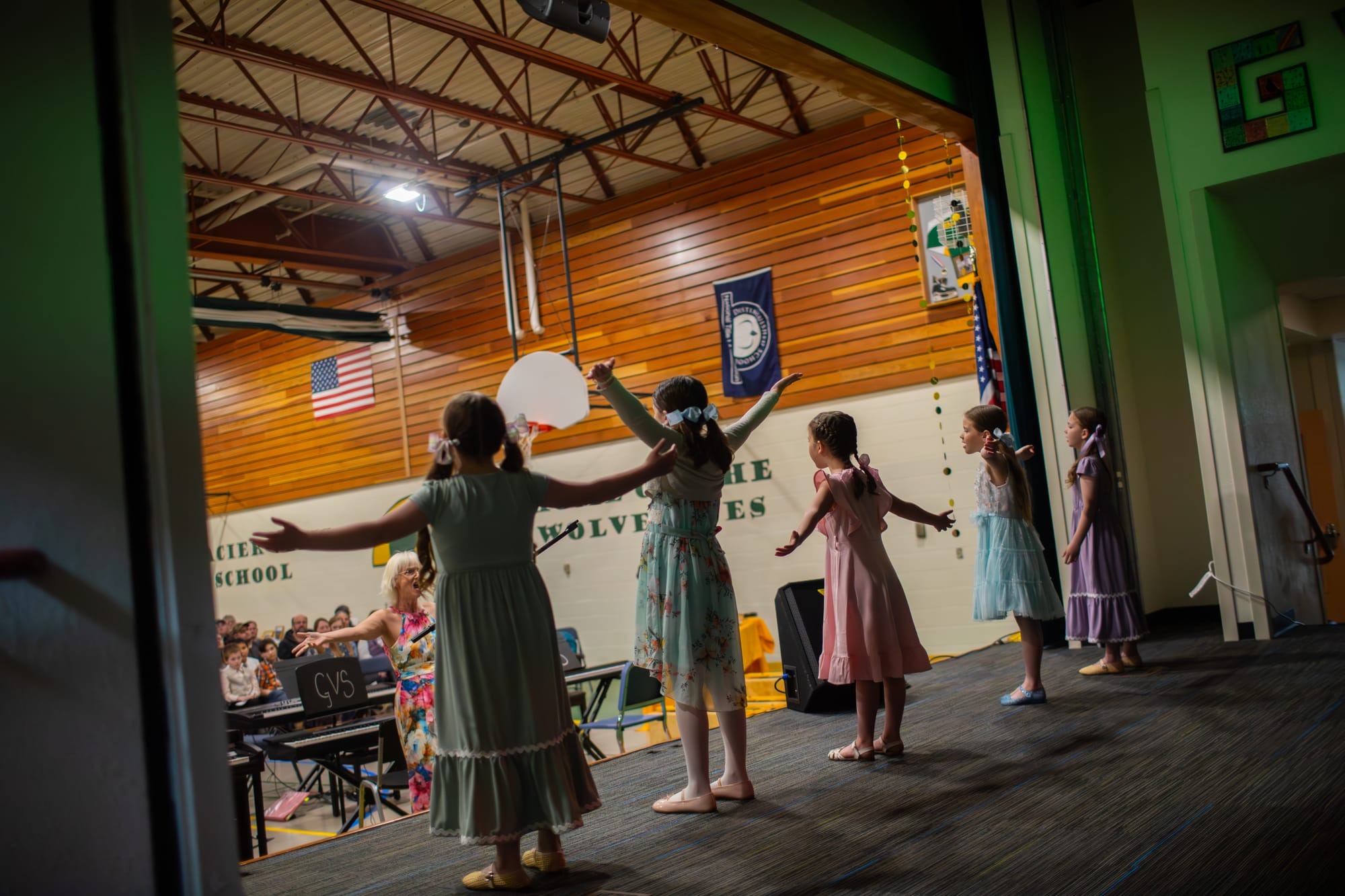 Glacier View Music Director Paula Gray leads first and second graders Aubree Yoder, Hannah Wilbert, Lucy Schroeder Gabrielle Brooks and Kallie Yoder