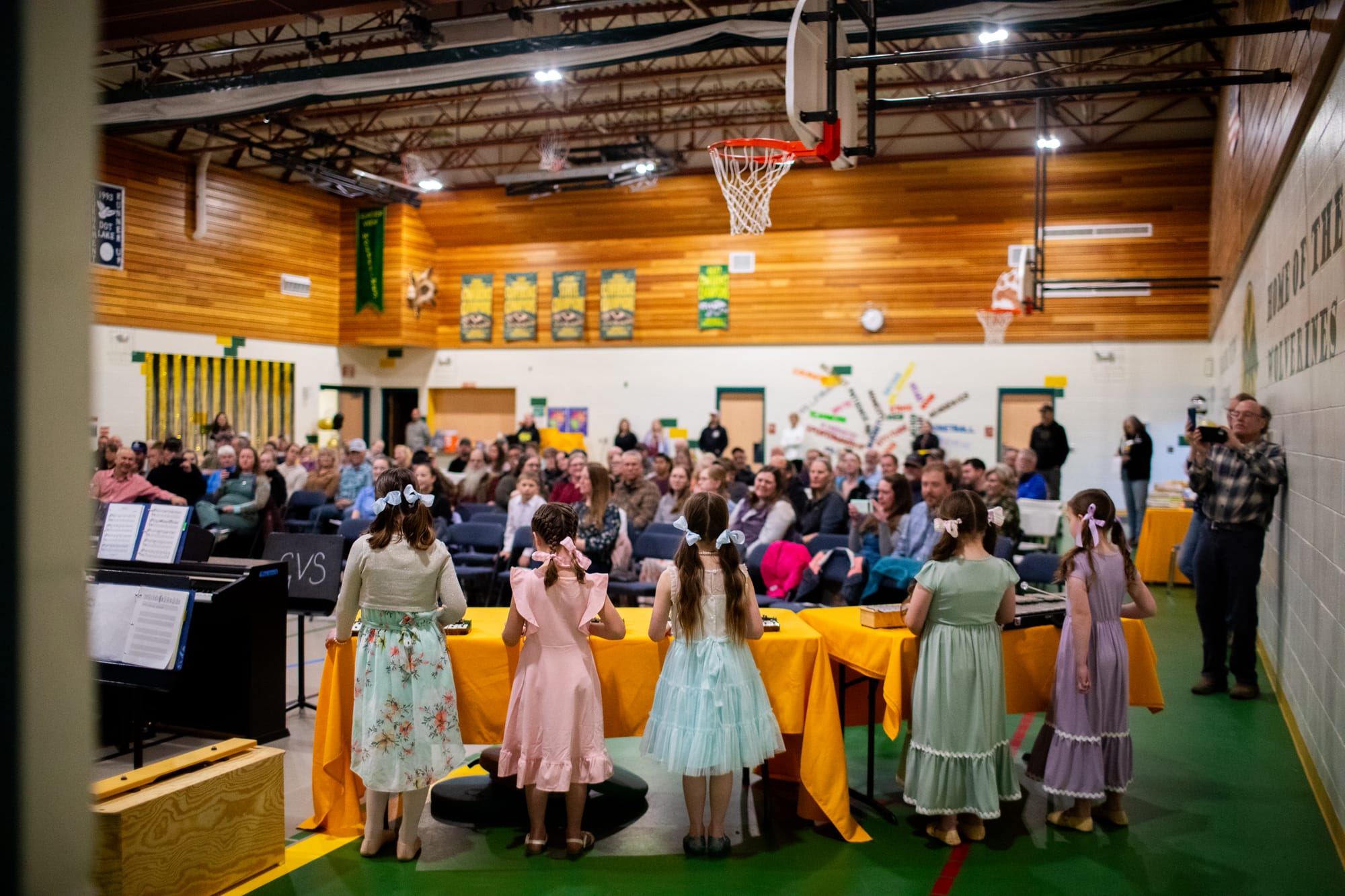 Glacier View School first- and second-grade students play alongside the large piano ensemble