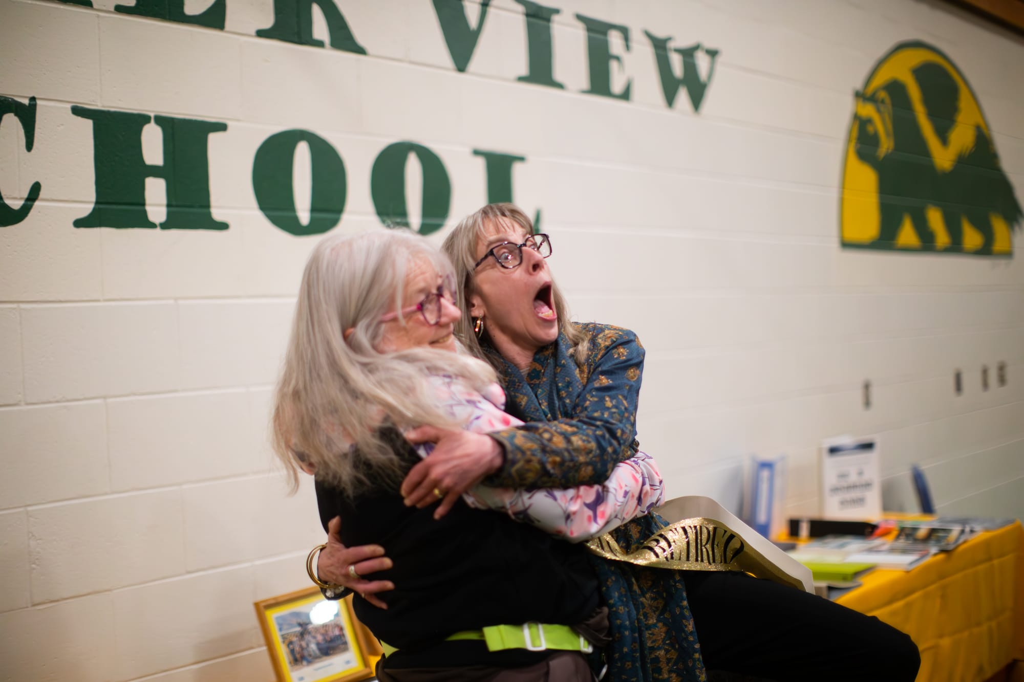 Randi Hirschmann, left, hugs Glacier View Principal Wendy Taylor