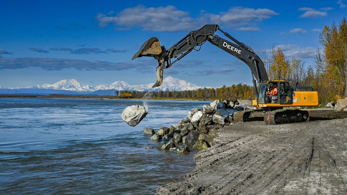 A contractor places boulders to shore up the bank of the Susitna River in September, 2023 in Talkeetna. (Stefan Hinman / Mat-Su Borough)