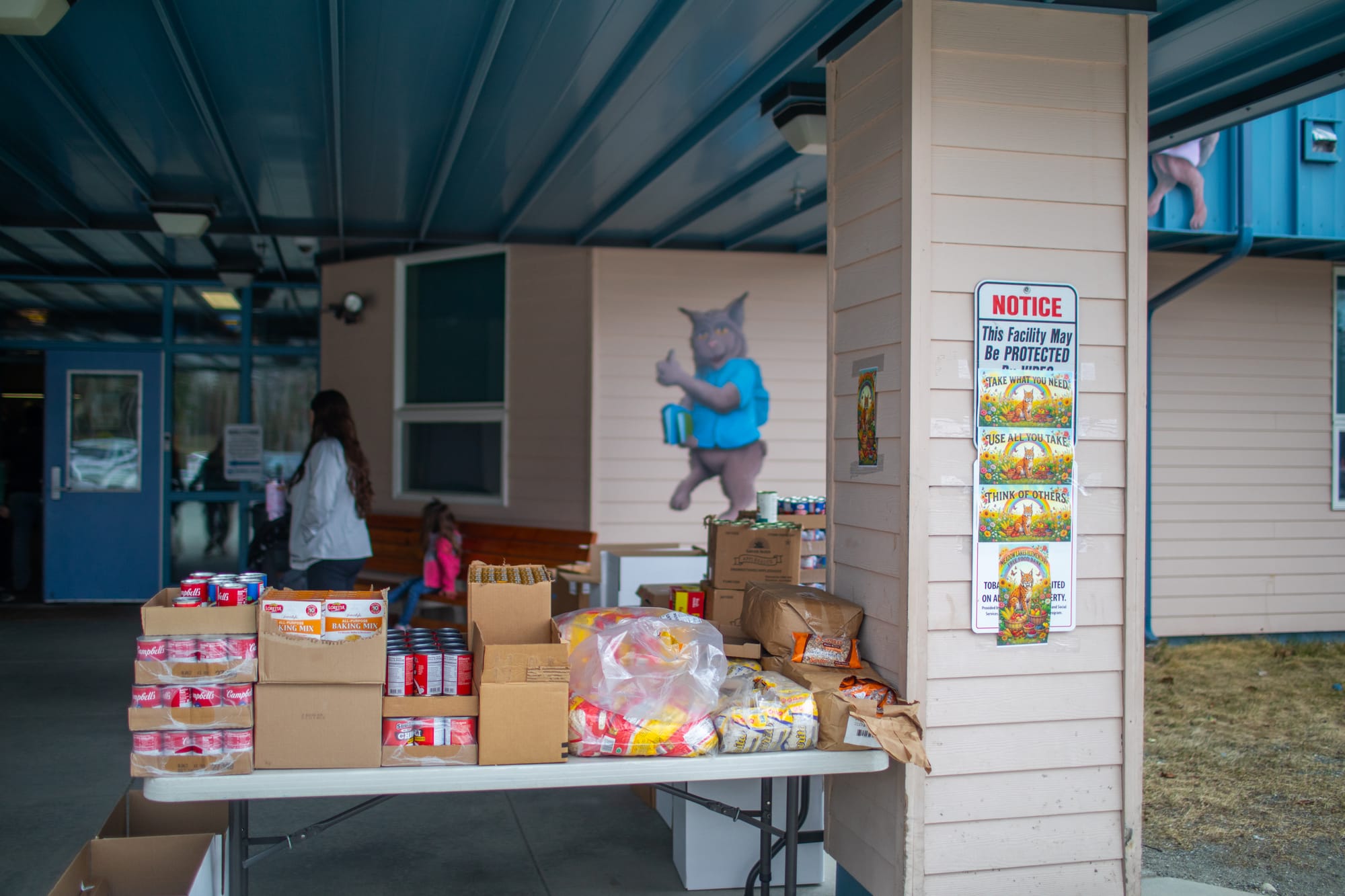 Leftovers from a school food bank sit at the front entrance at Meadow Lakes Elementary