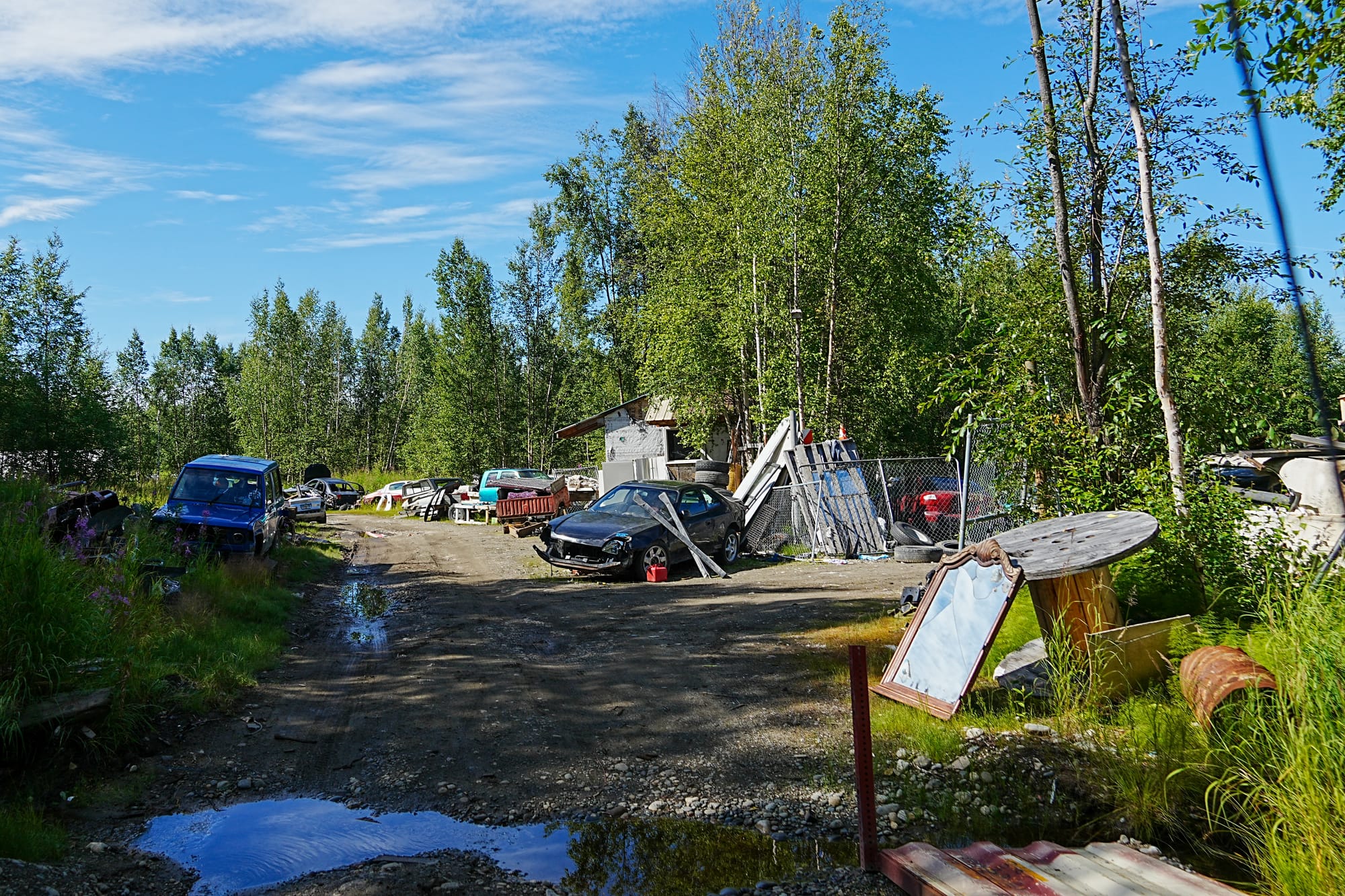 Junk and trash line a section of Peaceful Place in Big Lake