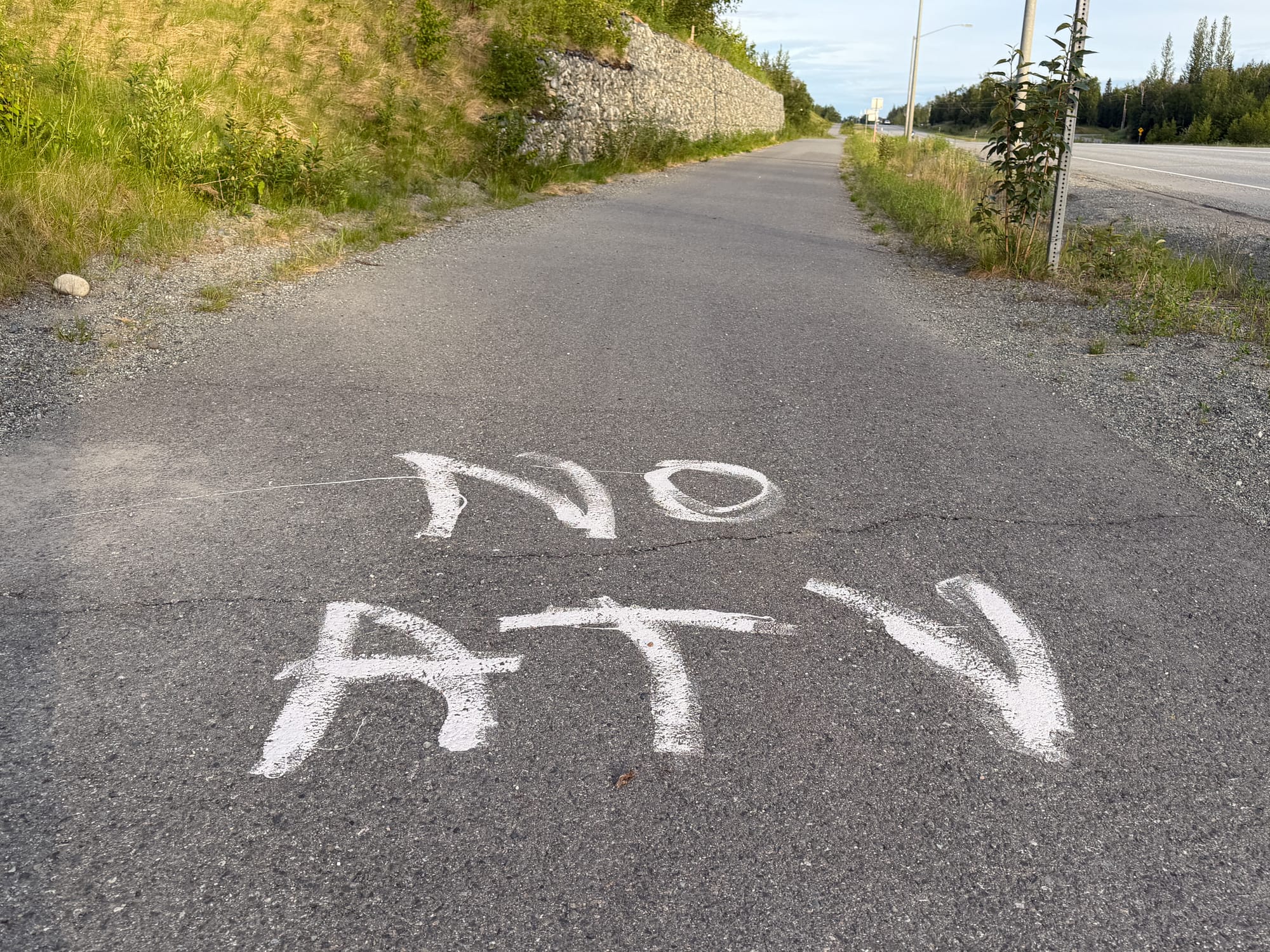 "NO ATV" graffiti in white on paint on the Bogard Road separated pathway