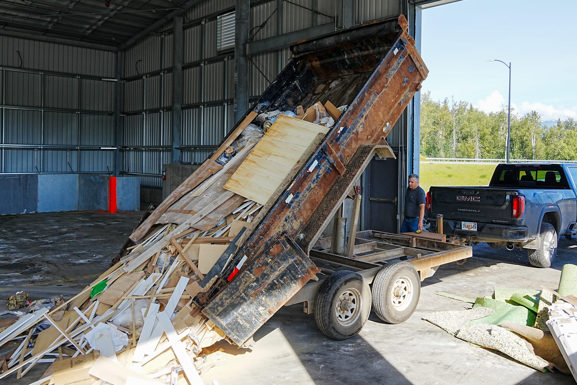 Wasilla resident Alex Drbenko dumps his trailer
