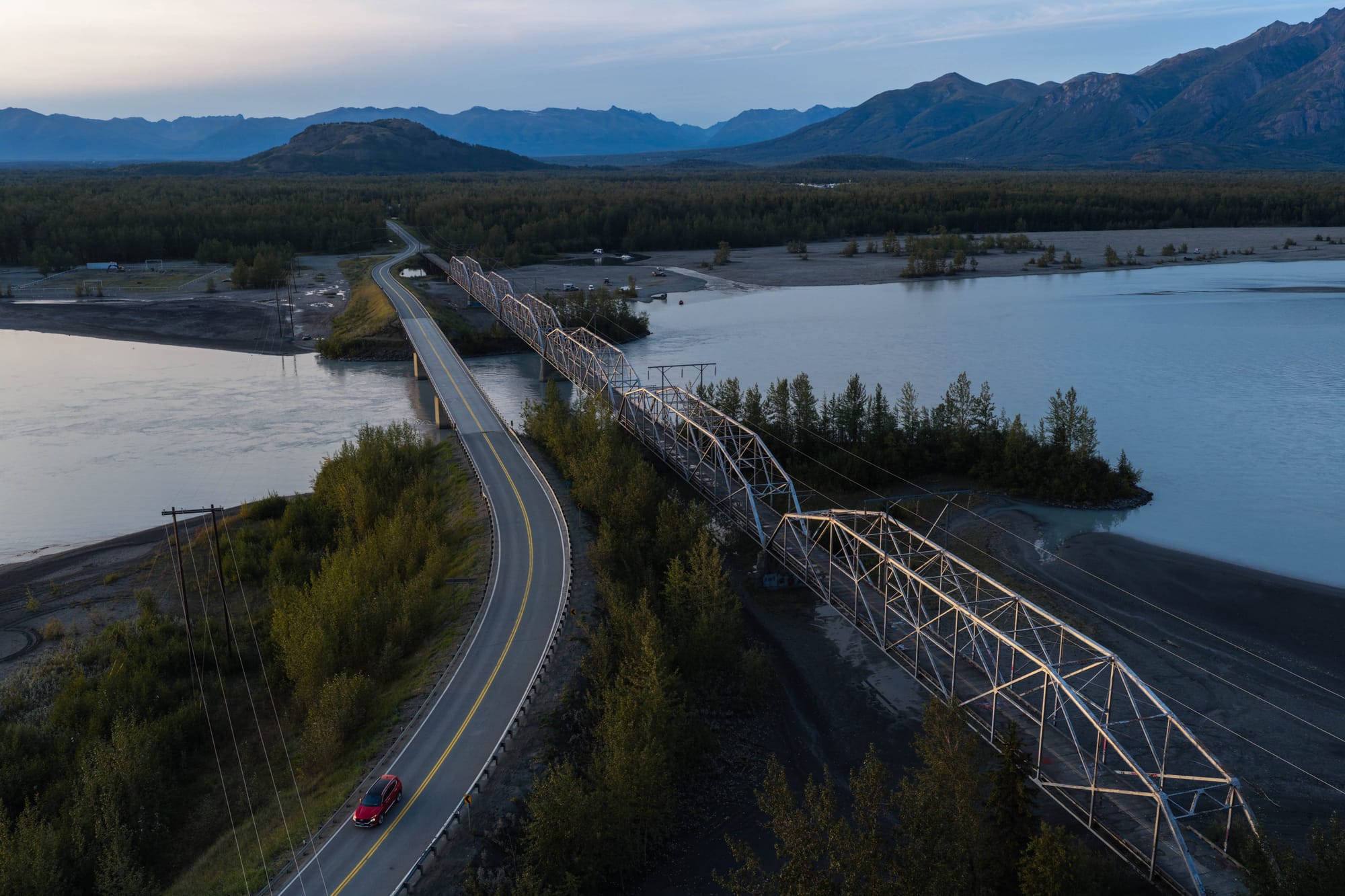 A vehicle crosses the Knik River on the Old Glenn Highway