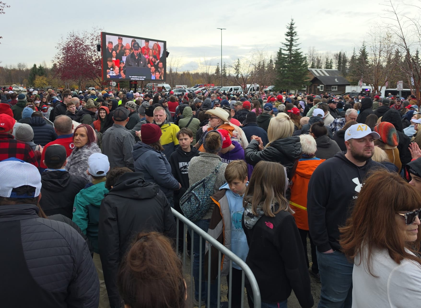Crowds watch U.S. Sen. Dan Sullivan speak via a jumbotron