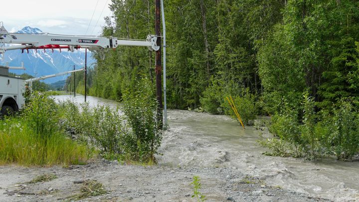 Matanuska Electric Association trucks stabalize a series of poles