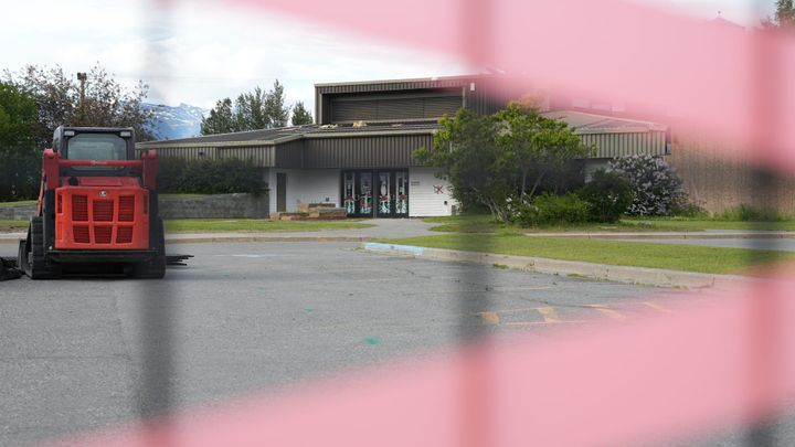 Fencing and tape block off the Palmer Public Library building