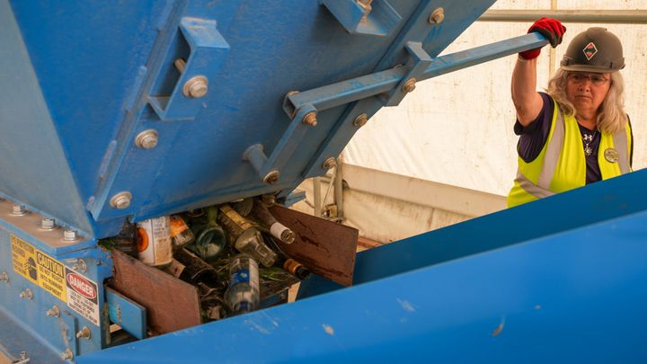 Pam Ness processes glass through the pulverizer at Valley Community for Recycling Solutions