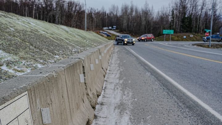 Drivers turn near a large construction berm at the intersection of Palmer-Fishhook and Trunk Road