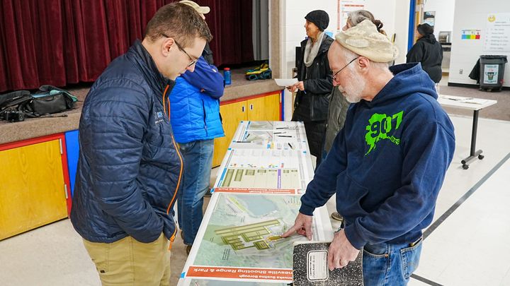 Mat-Su resident Scott Lapiene speaks with a project contractor